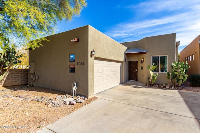 pueblo-style house with a garage