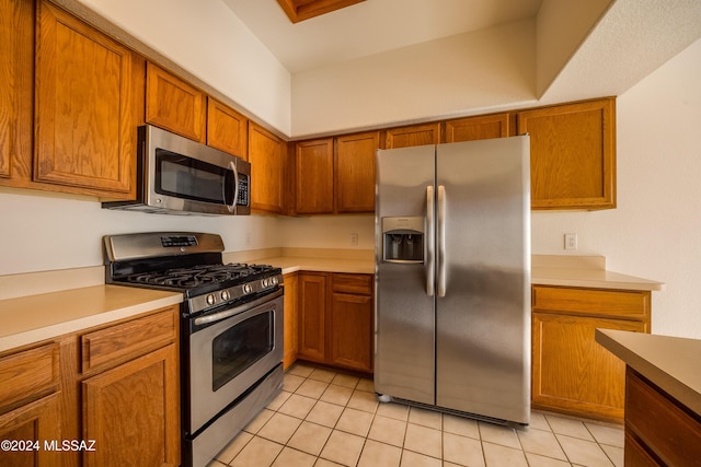 kitchen featuring light tile patterned floors and appliances with stainless steel finishes