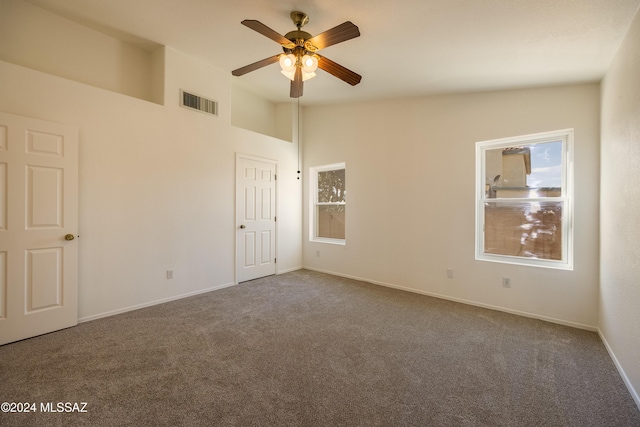 spare room with carpet, ceiling fan, and lofted ceiling