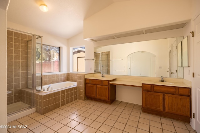 bathroom with tile patterned flooring, shower with separate bathtub, vanity, and vaulted ceiling