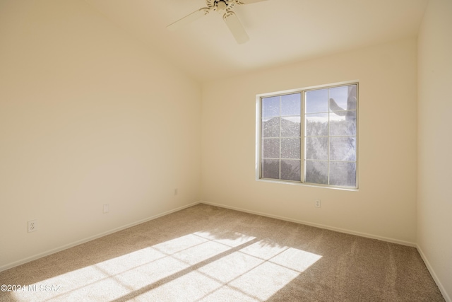 carpeted empty room with ceiling fan and vaulted ceiling