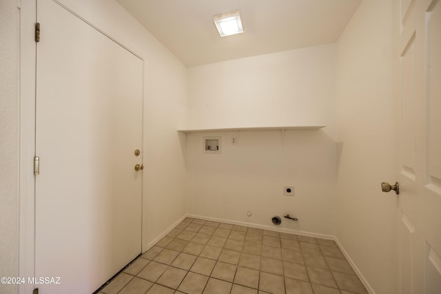 laundry area with electric dryer hookup, gas dryer hookup, hookup for a washing machine, and light tile patterned floors