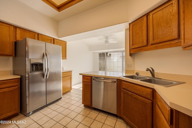 kitchen featuring kitchen peninsula, appliances with stainless steel finishes, ceiling fan, sink, and light tile patterned floors