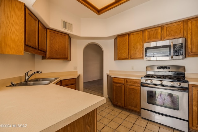 kitchen with light tile patterned flooring, sink, and stainless steel appliances