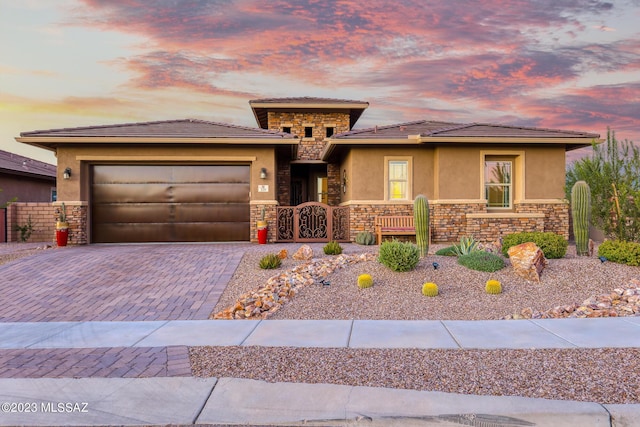 prairie-style home featuring a garage