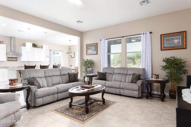 living room featuring a healthy amount of sunlight and light tile patterned floors