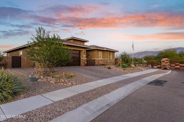 view of front facade featuring a mountain view and a garage