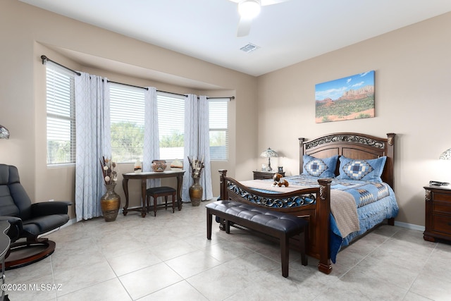 tiled bedroom featuring ceiling fan and multiple windows