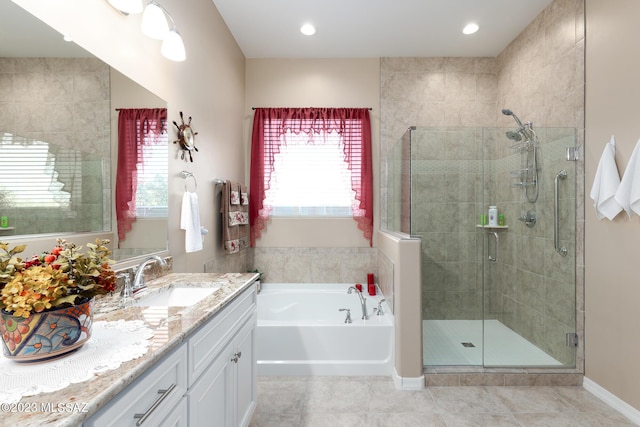 bathroom featuring tile patterned floors, vanity, and shower with separate bathtub