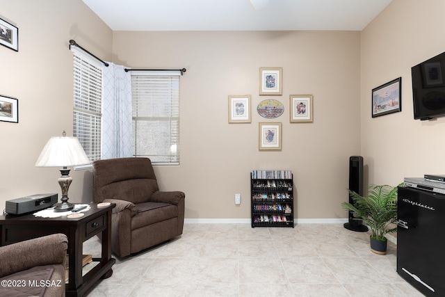 living area with light tile patterned floors and beverage cooler