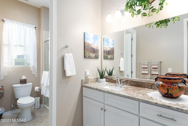 bathroom with vanity, toilet, and walk in shower