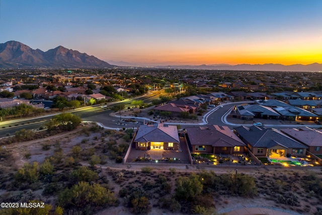 aerial view at dusk featuring a mountain view