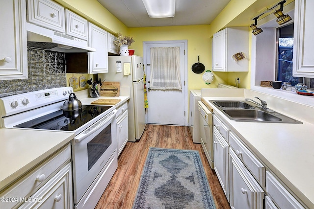 kitchen with sink, tasteful backsplash, wood-type flooring, white appliances, and white cabinets