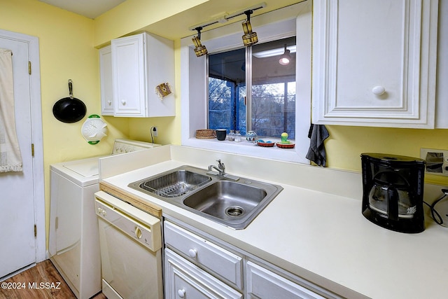 kitchen featuring white cabinetry, sink, dark hardwood / wood-style flooring, white dishwasher, and washer / dryer