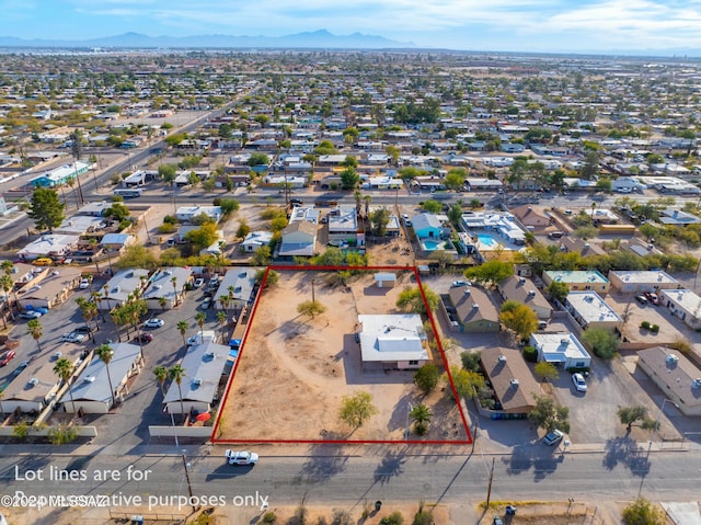 birds eye view of property featuring a mountain view