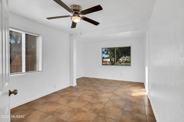 unfurnished room with tile patterned floors and ceiling fan