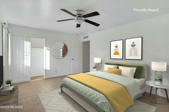 tiled bedroom with a closet and ceiling fan