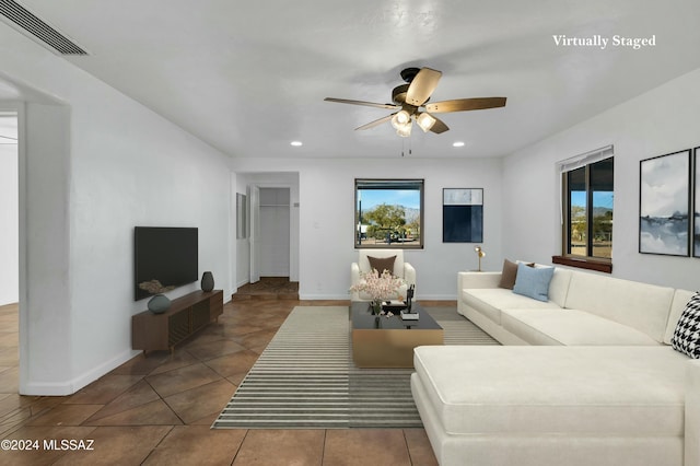 tiled living room featuring ceiling fan and a wealth of natural light