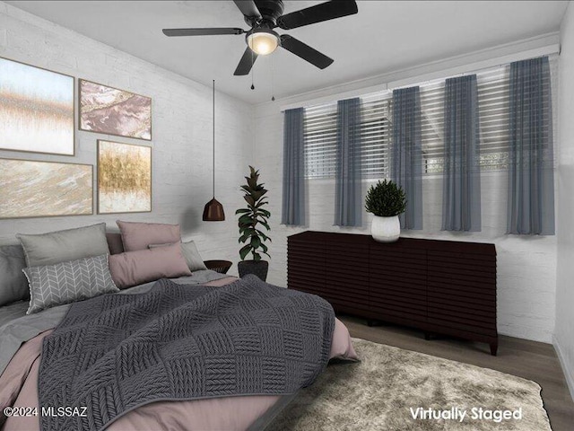 bedroom with ceiling fan and hardwood / wood-style flooring