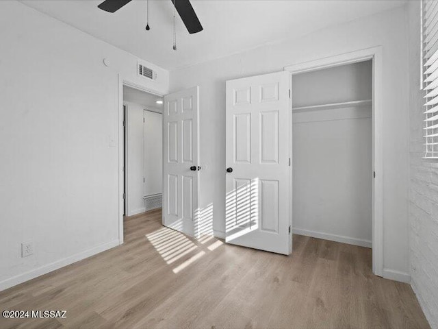 unfurnished bedroom featuring a closet, ceiling fan, and light hardwood / wood-style flooring