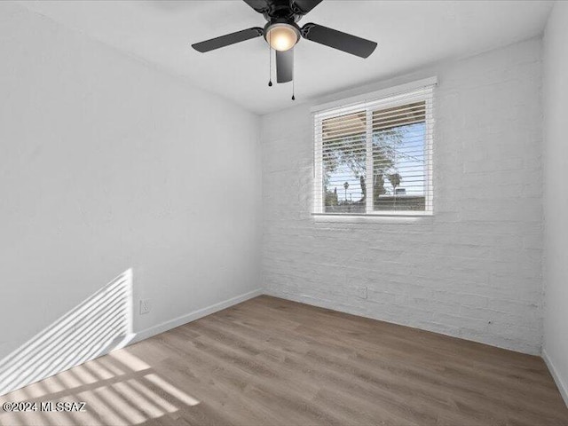 spare room featuring ceiling fan and hardwood / wood-style floors