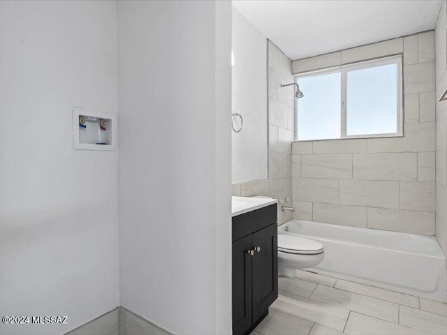 full bathroom with vanity, toilet, and tiled shower / bath combo