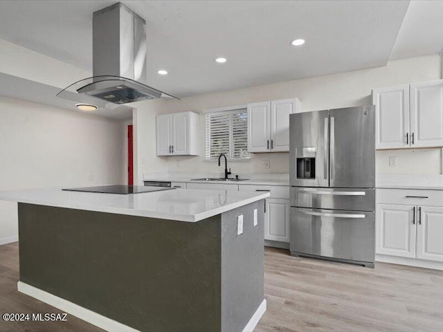 kitchen with a center island, sink, stainless steel refrigerator with ice dispenser, light wood-type flooring, and island exhaust hood