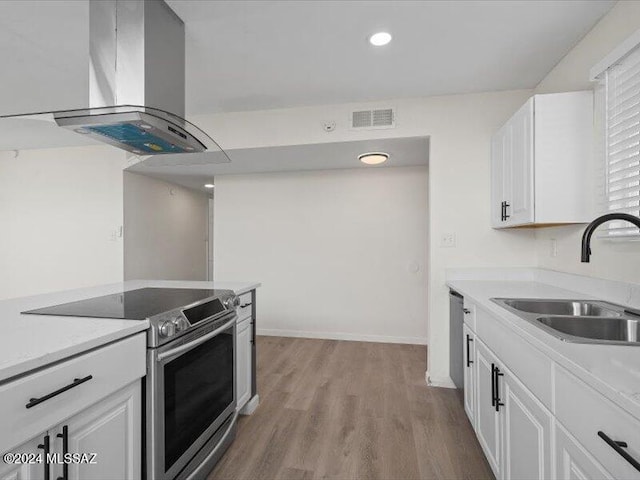 kitchen featuring white cabinets, island range hood, sink, and stainless steel appliances