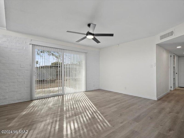 empty room with ceiling fan and wood-type flooring