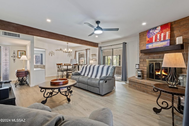 living room with ceiling fan, light hardwood / wood-style floors, beam ceiling, and a brick fireplace