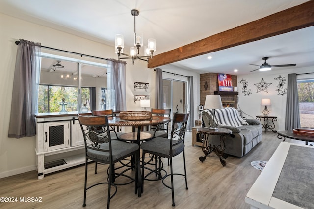 dining room featuring hardwood / wood-style floors, beamed ceiling, and ceiling fan with notable chandelier