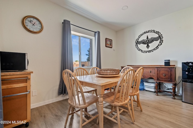 dining space featuring light wood-type flooring