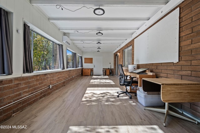 hall with beamed ceiling, hardwood / wood-style floors, a wall mounted AC, and brick wall