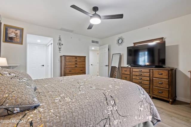 bedroom with ceiling fan and light hardwood / wood-style floors