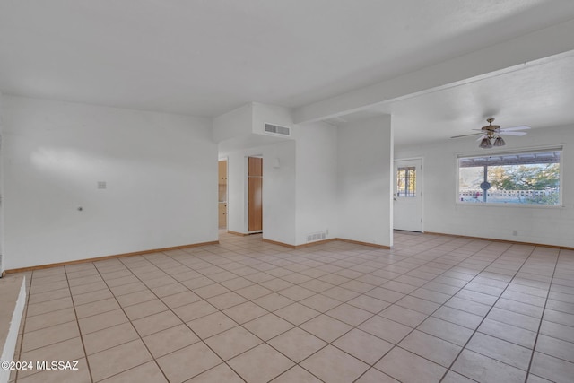 spare room with ceiling fan and light tile patterned flooring