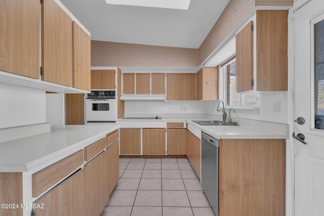 kitchen with dishwasher, sink, white oven, vaulted ceiling, and light tile patterned floors