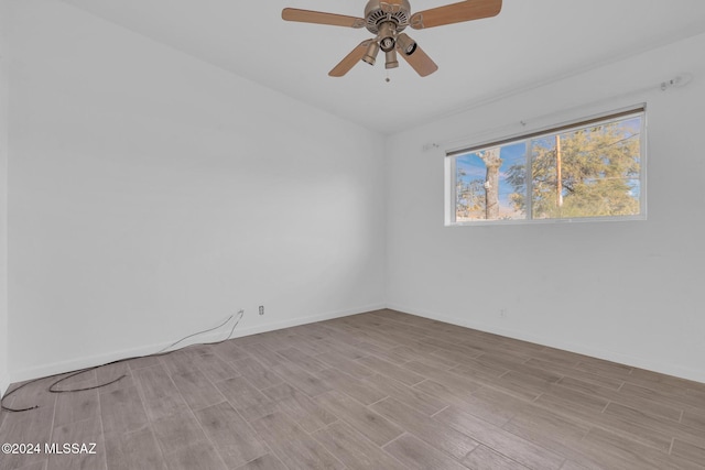 unfurnished room with light hardwood / wood-style flooring and ceiling fan