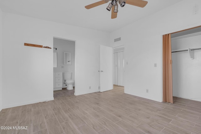 unfurnished bedroom with ensuite bathroom, a closet, ceiling fan, and light hardwood / wood-style floors