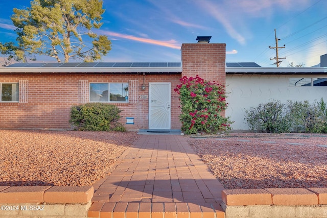 view of front of property with solar panels