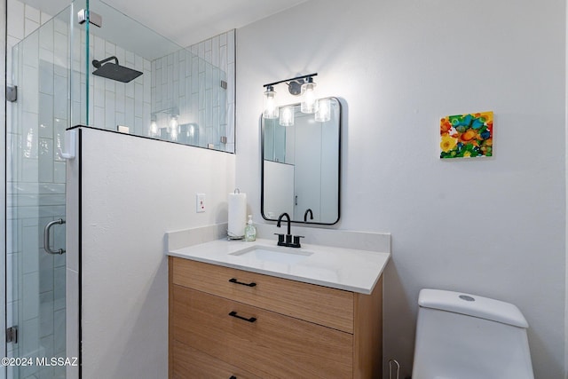 bathroom with vanity, toilet, and an enclosed shower