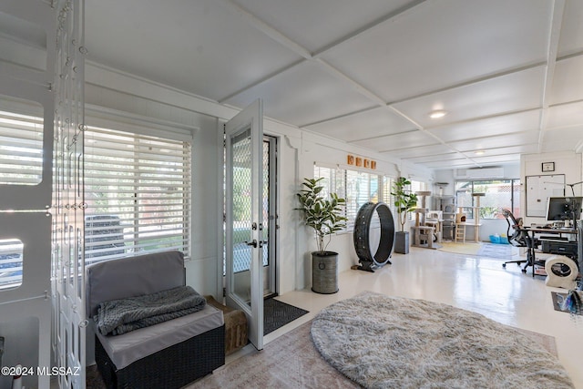 interior space featuring a wall unit AC and coffered ceiling