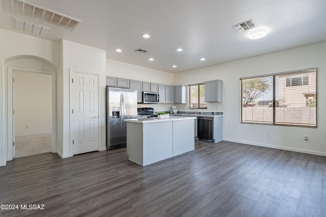 kitchen featuring sink, black appliances, gray cabinets, a kitchen island, and dark hardwood / wood-style floors