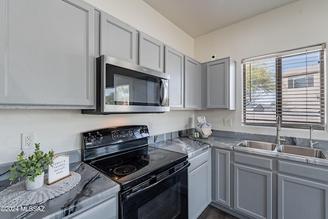 kitchen with black / electric stove, gray cabinetry, and sink