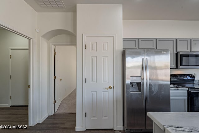 kitchen featuring dark wood-type flooring, stainless steel appliances, and gray cabinetry