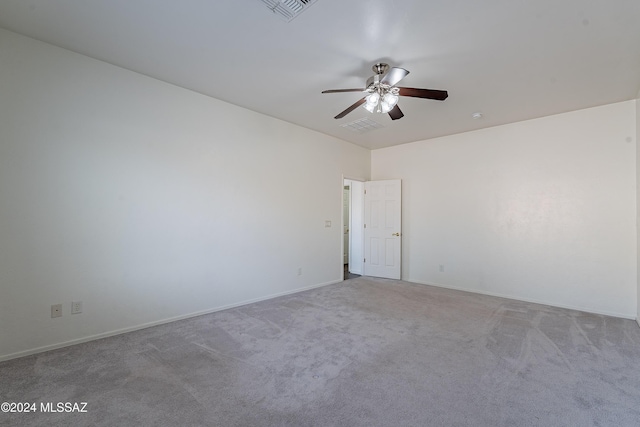 carpeted empty room featuring ceiling fan