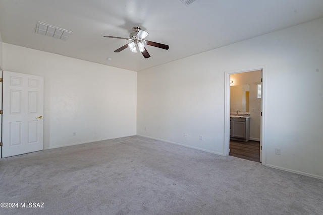 empty room featuring light colored carpet and ceiling fan