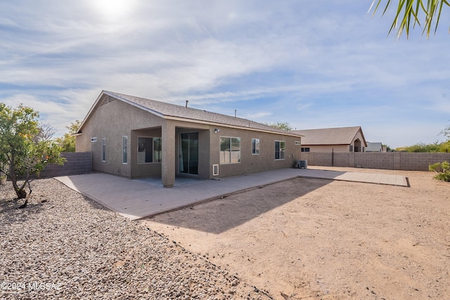 back of house featuring cooling unit and a patio