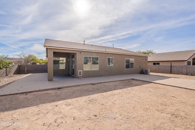 rear view of property featuring a patio and cooling unit