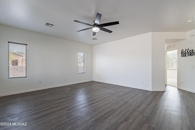 unfurnished room with ceiling fan and dark hardwood / wood-style floors