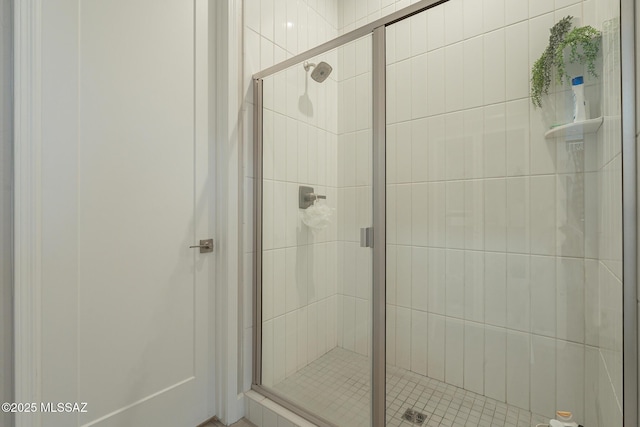 bathroom featuring a shower with shower door